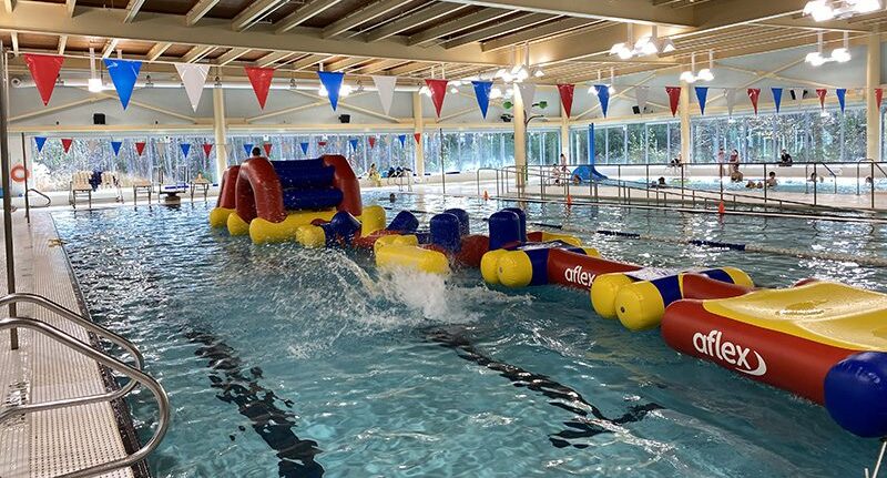 A large, inflatable obstacle course floats in the LCLC pool.