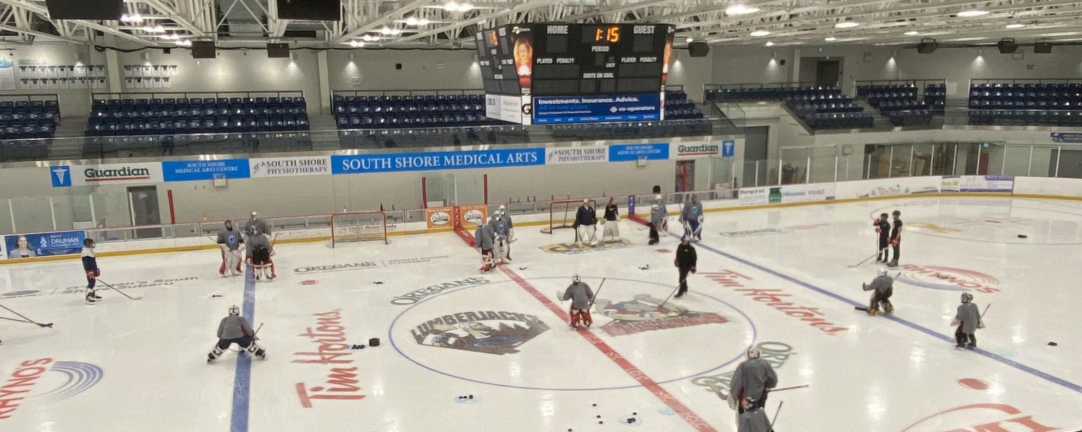 A view of the LCLC arena ice from the seating area. Kids are seen on the ice wearing hockey gear.